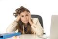 Businesswoman suffering stress at office computer desk looking worried depressed and overwhelmed Royalty Free Stock Photo