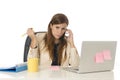 Businesswoman suffering stress at office computer desk looking worried depressed and overwhelmed Royalty Free Stock Photo