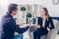 Businesswoman in suit giving interview to journalist and gesturing Royalty Free Stock Photo