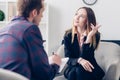 Businesswoman in suit giving interview to journalist, gesturing and looking up Royalty Free Stock Photo