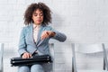 Businesswoman in suit holding briefcase and checking Royalty Free Stock Photo