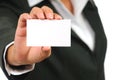 Businesswoman in suit holding empty business card