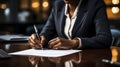 A businesswoman with a suit signing her signature on document, Hand Holding pen writing down or filling out on blank form paper Royalty Free Stock Photo