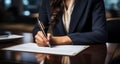 A businesswoman with a suit signing her signature on document, Hand Holding pen writing down or filling out on blank form paper in Royalty Free Stock Photo
