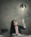 Businesswoman switching on idea light bulb Royalty Free Stock Photo