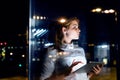 Businesswoman with tablet working late at night.