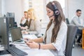 Businesswoman taking notes from phone to notebook during talk with client. Royalty Free Stock Photo