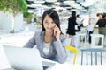 Businesswoman talk to mobile phone and using laptop computer Royalty Free Stock Photo