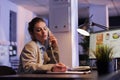 Businesswoman talking at landline phone with coworker