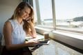 Businesswoman talking on mobile phone while using digital tablet Royalty Free Stock Photo