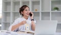 Businesswoman is talking on mobile phone in working office. beautiful of Asian woman is calling to someone on cell phone Royalty Free Stock Photo