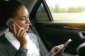 Businesswoman talking on a phone and using digital tablet Royalty Free Stock Photo