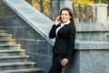 Businesswoman talking on phone while walking outdoor Royalty Free Stock Photo