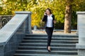 Businesswoman talking on phone while walking outdoor Royalty Free Stock Photo