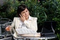 Businesswoman talking on the phone while working with documents and holding a glass of wine Royalty Free Stock Photo