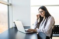 Businesswoman talking on the phone while working on her computer Royalty Free Stock Photo