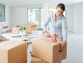 Businesswoman taping up a cardboard box Royalty Free Stock Photo