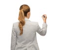 Businesswoman or teacher with marker from back Royalty Free Stock Photo