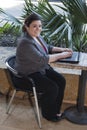Businesswoman - Telecommuting from Internet Cafe Royalty Free Stock Photo