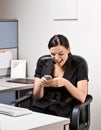 Businesswoman text messaging on cell phone Royalty Free Stock Photo