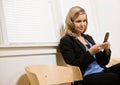 Businesswoman text messaging on cell phone Royalty Free Stock Photo