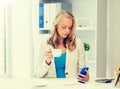 Businesswoman texting on smartphone at office Royalty Free Stock Photo