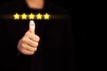 Businesswoman thumbs up which print screen face smile with five stars above finger. Royalty Free Stock Photo