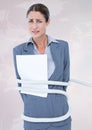 Businesswoman tied up with rope and paper against white background