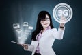Businesswoman touches 5G network symbol