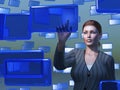 Businesswoman touching blue screen
