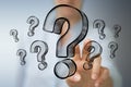 Businesswoman touching and holding hand drawn question marks Royalty Free Stock Photo