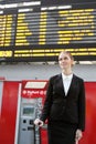 Businesswoman and train timetable