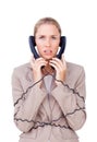 Businesswoman trangled up in telephone wires Royalty Free Stock Photo