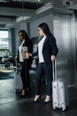 Businesswoman with travel bag pushing button Royalty Free Stock Photo