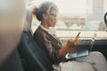 Businesswoman traveling on bus transport service transfer and writing message on mobile phone. One modern woman reading Royalty Free Stock Photo