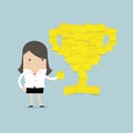 Businesswoman with trophy cup yellow sticky notes.