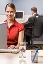 Businesswoman typing on computer at desk