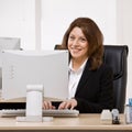 Businesswoman typing on computer at desk