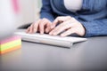 Businesswoman typing in data to her computer