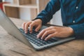 businesswoman is typing on her laptop at work, searching or transacting online, and working on her finance business Royalty Free Stock Photo