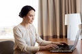 Businesswoman typing on laptop at hotel room Royalty Free Stock Photo