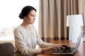 Businesswoman typing on laptop at hotel room Royalty Free Stock Photo