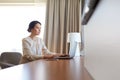 Businesswoman typing on laptop at hotel room Royalty Free Stock Photo