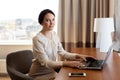 Businesswoman typing on laptop at hotel room Royalty Free Stock Photo