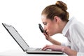 Businesswoman typing and looking through magnifying glass