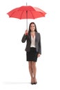Businesswoman under red umbrella