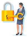 Businesswoman unlocking huge padlock with key. Royalty Free Stock Photo