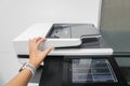 Businesswoman use multi function printer to scan documents in office