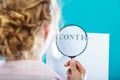 Businesswoman uses magnifying glass to check contract Royalty Free Stock Photo