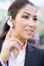 Businesswoman using bluetooth earpiece